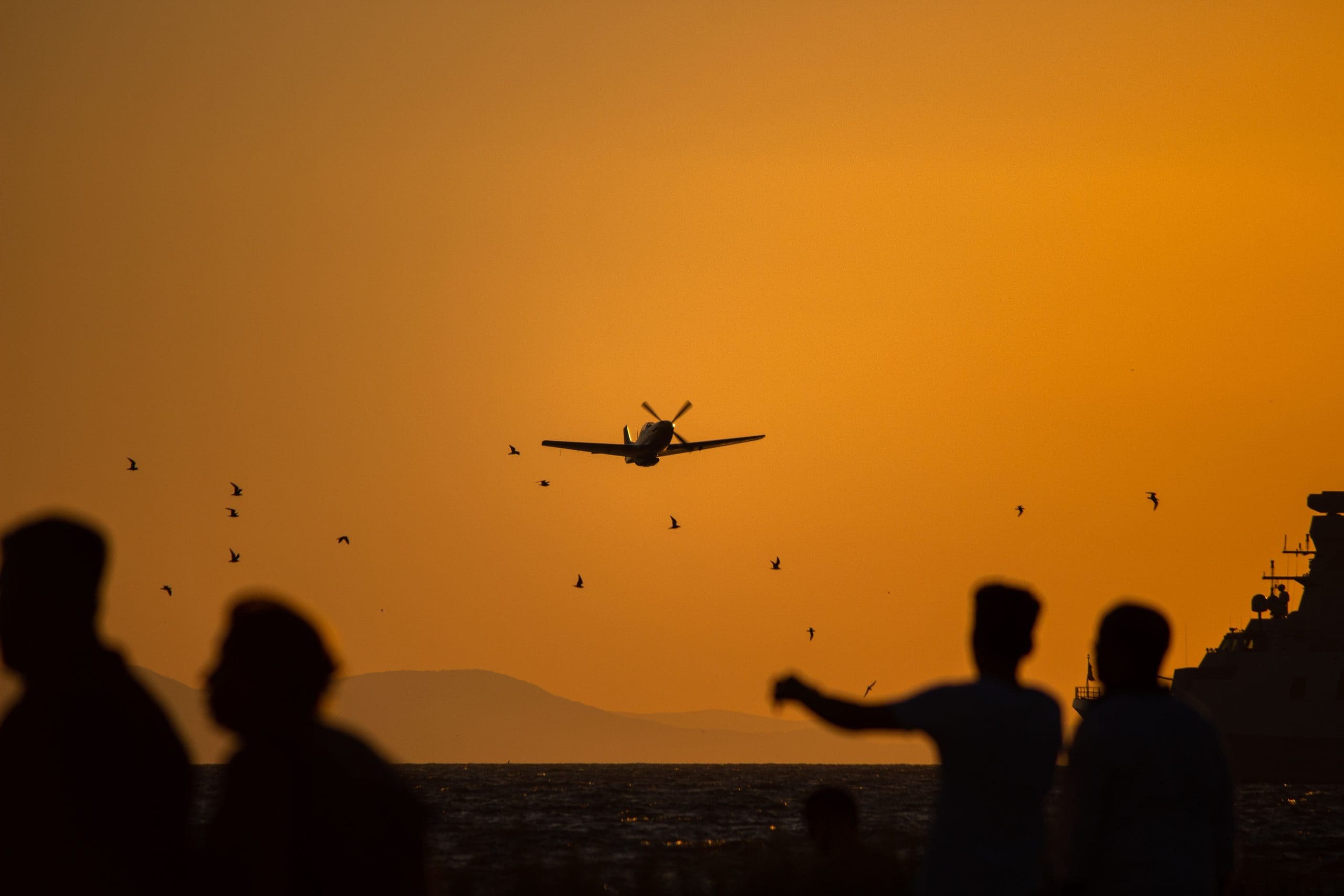 Veteran P-51 Mustang against an orange sunset